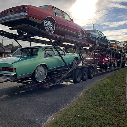 The main type of carrier on the road is the open auto transport carrier, which is the most widely seen and is considered to be the standard method of shipping a vehicle. Open carriers can handle most personal vehicles on the road; that is, they can fit most cars, sport utility vehicles and pickup trucks, as well as cargo and mini vans. Because of their versatility, most auto shipping companies, including the vast majority of independent owner-operators on the road, operate open car shipping trucks. With many being able to hold upwards of ten vehicles at a time, maximizing the amount of money they make on a route with an open transport truck is much easier than with other types of haulers. This generally leads to the lowest prices in the industry.​